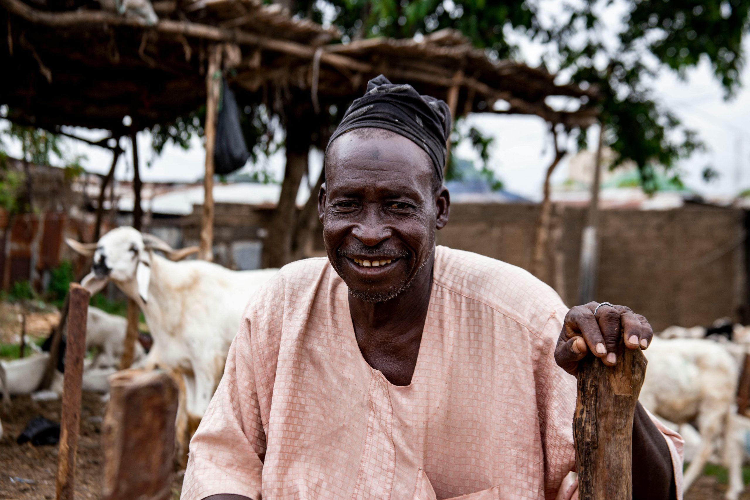 Portrait of an African farmer smiling on a goat farm in Nigeria.