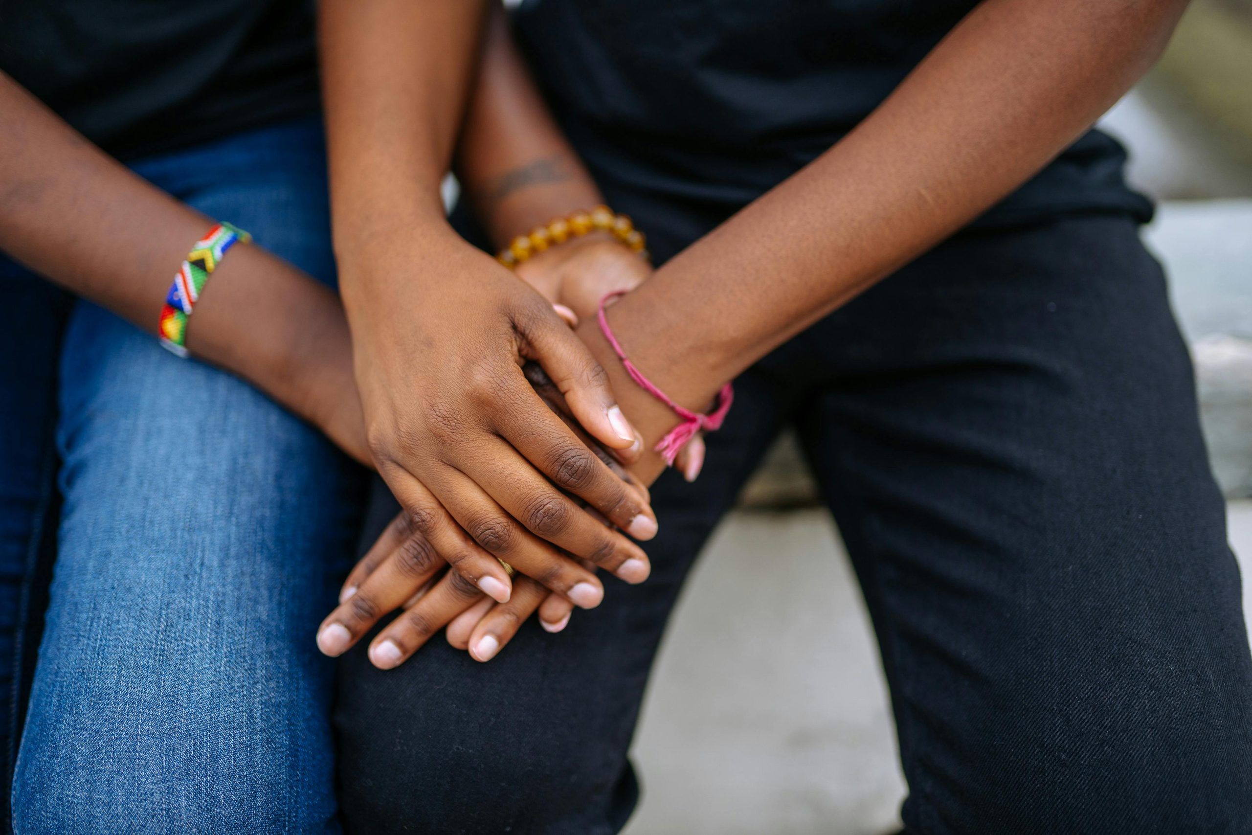 A close-up image of two adults holding hands, symbolizing love and connection.